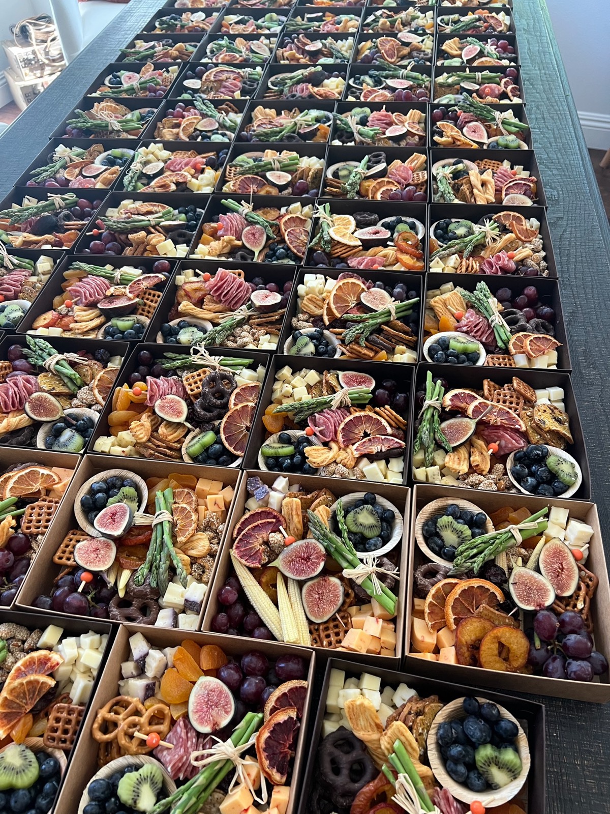 Rows of individual charcuterie boxes for an event